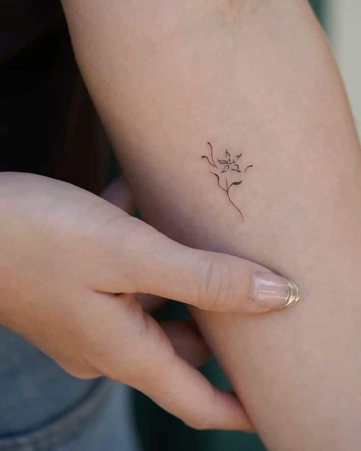 Abstract flower 🌷 Minimalist flower tattoo on forearm, hand touching it gently. Simple line art with delicate detail. | Sky Rye Design Minimalist flower tattoo on forearm, hand touching it gently. Simple line art with delicate detail.