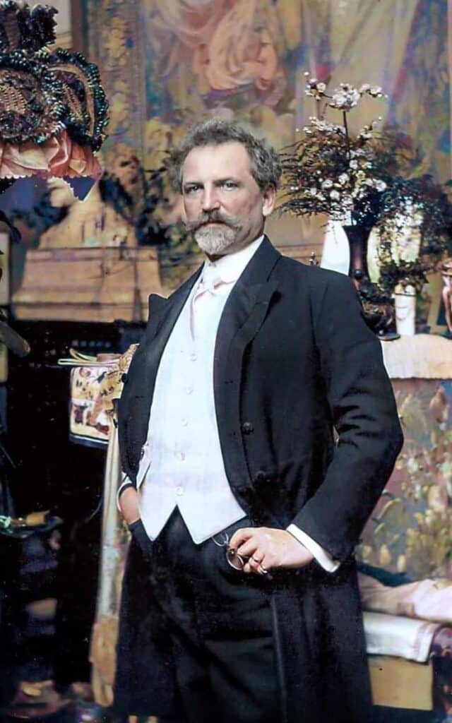 Distinguished gentleman in formal Victorian attire poses confidently in an ornate room.