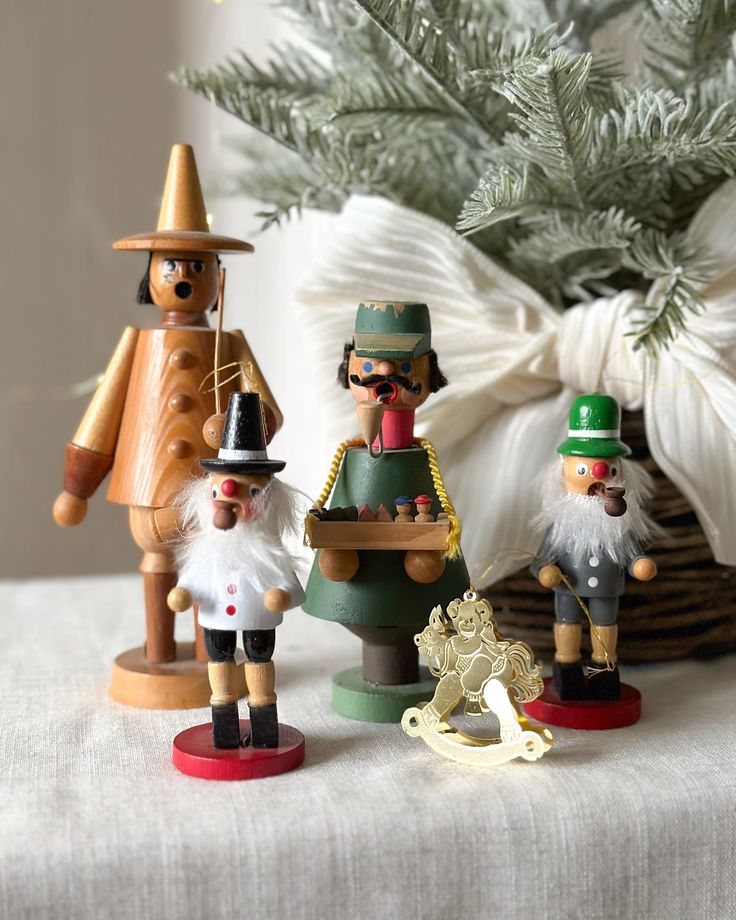 Available __Mini smoker wood ornaments_ __ Each__Black Hat Available __Comment mine to claim Collection of wooden nutcracker dolls with festive decorations and fir branches in the background. | Sky Rye Design Collection of wooden nutcracker dolls with festive decorations and fir branches in the background.