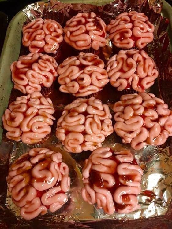 Brains 🧠 Halloween cupcakes designed to look like brains, with pink icing and red syrup, arranged on foil. | Sky Rye Design Halloween cupcakes designed to look like brains, with pink icing and red syrup, arranged on foil.