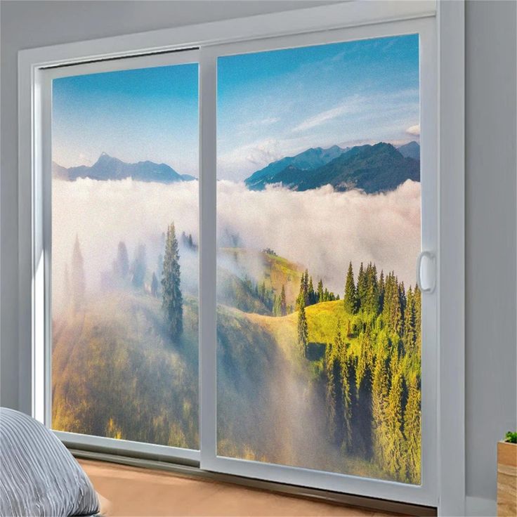 Customized Size Misty Mountain View Window Film Privacy Frosted PVC Anti-UV Static Cling for Bathroom Door Glass Window Stickers Scenic view of a misty mountain landscape with trees, seen through a large sliding window, under a clear blue sky. | Sky Rye Design Scenic view of a misty mountain landscape with trees, seen through a large sliding window, under a clear blue sky.