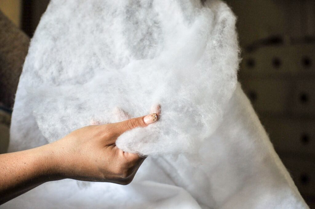 File_002-5 Hand holding soft, fluffy cotton fabric, showcasing texture and quality close-up. Ideal for textile and crafting keywords. | Sky Rye Design Hand holding soft, fluffy cotton fabric, showcasing texture and quality close-up. Ideal for textile and crafting keywords.