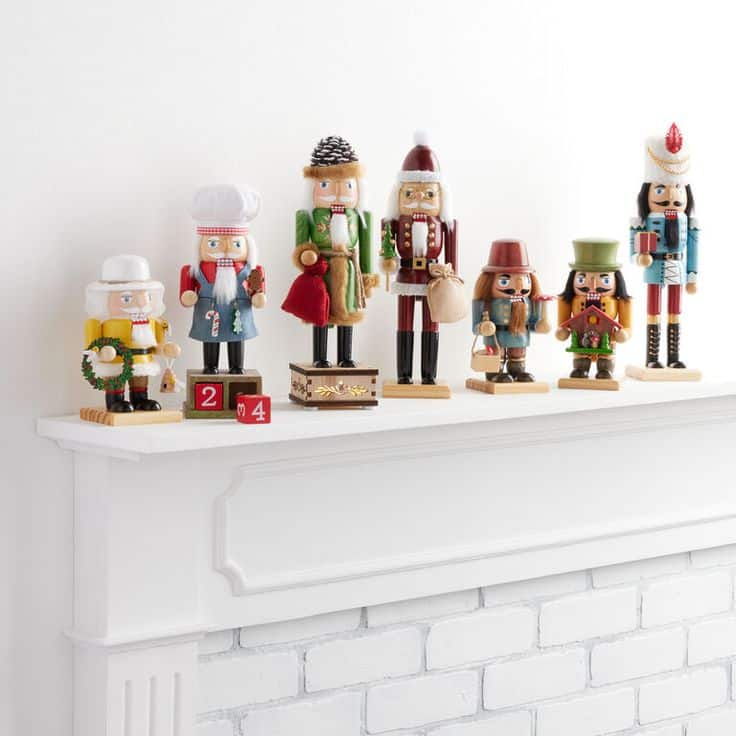 German Style Nutcrackers Set Of 2 - World Market Festively decorated mantel with diverse nutcracker figures, adding a touch of holiday charm and warmth. | Sky Rye Design Festively decorated mantel with diverse nutcracker figures, adding a touch of holiday charm and warmth.