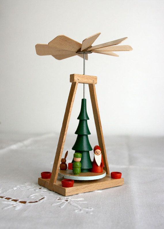 German-pyramid-christmas-tree these are adorable Wooden Christmas pyramid with tree, Santa, and candles on white cloth. Festive decoration with natural finish. | Sky Rye Design Wooden Christmas pyramid with tree, Santa, and candles on white cloth. Festive decoration with natural finish.
