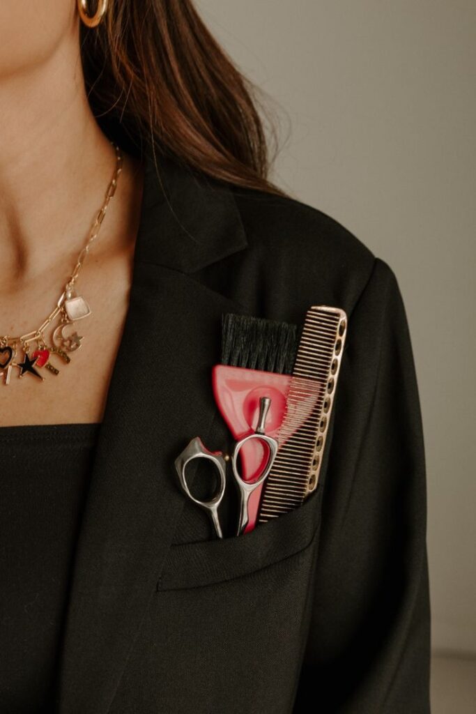 Hair tools in suit pocket. Scissors, comb, brush in jacket, stylish look for hairstylist or barber.