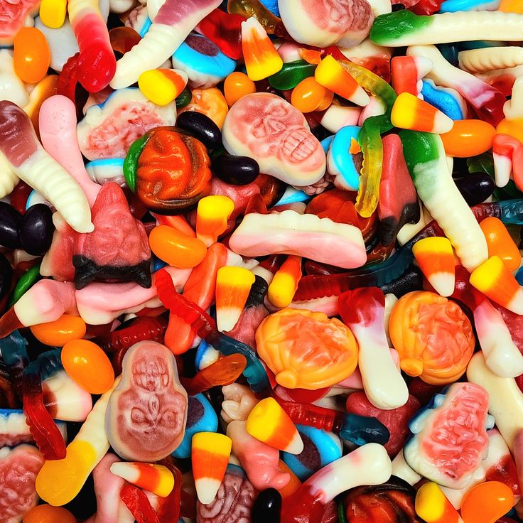 Halloween Lolly Mix Assorted colorful Halloween gummy candies with spooky shapes like skulls, worms, and pumpkins. | Sky Rye Design Assorted colorful Halloween gummy candies with spooky shapes like skulls, worms, and pumpkins.