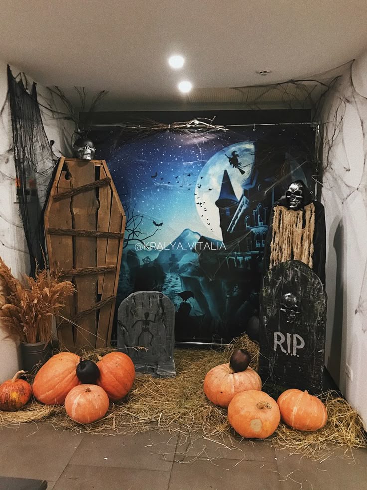 Haunted Halloween scene with pumpkins, coffin, skulls, and tombstones in front of a spooky night backdrop.
