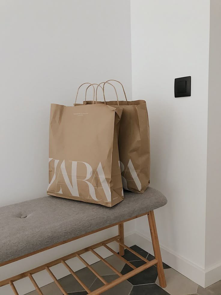 Shopping bags on a stylish bench in a modern interior space.