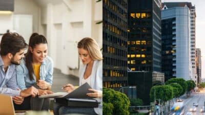 Coworkers reviewing documents in an office next to a bustling cityscape with tall buildings and a busy street.