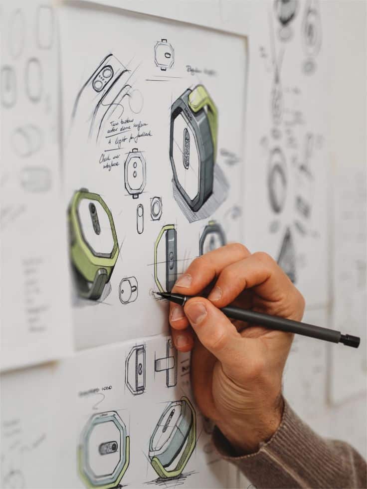 INDUSTRIAL DESIGN SKETCH Designer sketching a modern smartwatch concept with detailed notes and illustrations on paper. | Sky Rye Design Designer sketching a modern smartwatch concept with detailed notes and illustrations on paper.