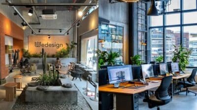 Modern coworking office with stylish design and greenery, showcasing workstations and seating areas under natural light.