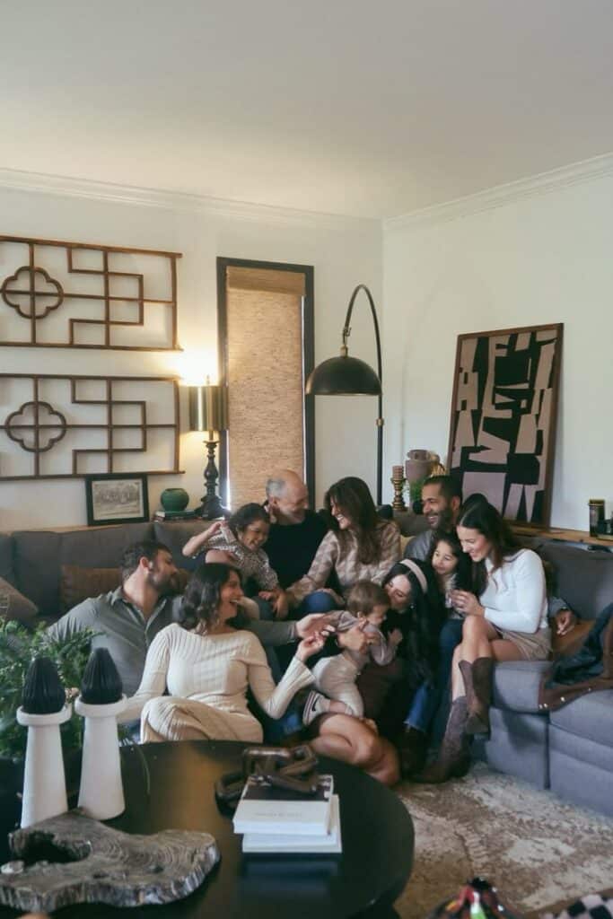 Family gathered in a cozy living room, smiling and enjoying quality time together on a comfortable couch.
