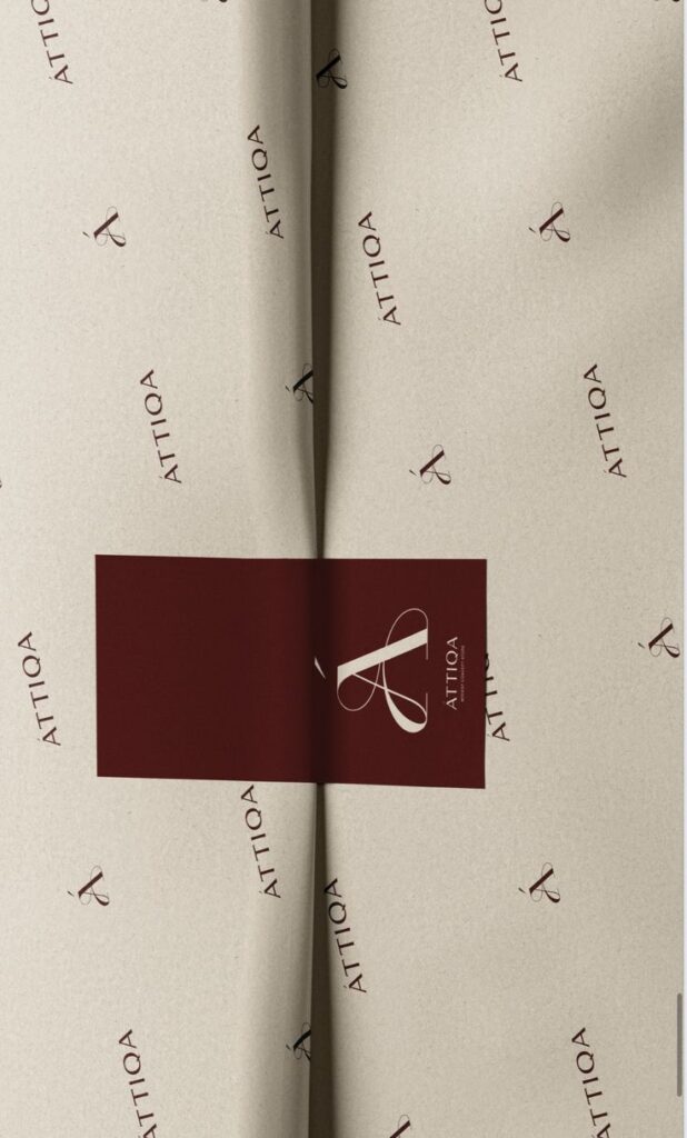Screenshot Elegant cream and maroon packaging with ATTIQA branding, featuring a stylized letter logo and modern design elements. | Sky Rye Design Elegant cream and maroon packaging with ATTIQA branding, featuring a stylized letter logo and modern design elements.