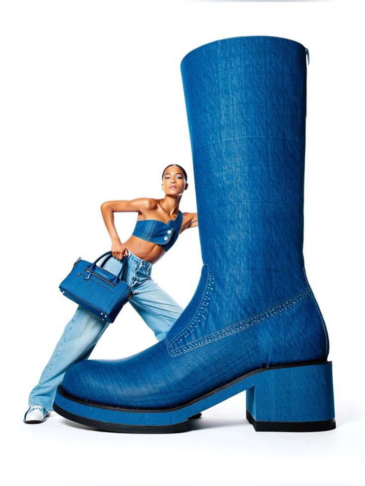 Love this fashion photography_ Save this for inspiration Model posing with oversized denim boot and matching bag, wearing denim fashion ensemble. | Sky Rye Design Model posing with oversized denim boot and matching bag, wearing denim fashion ensemble.