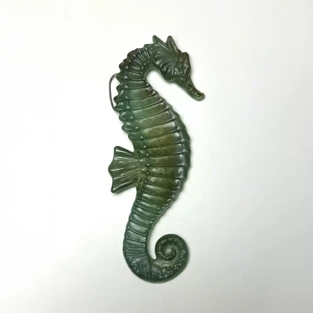 MOLF263-1 Green ceramic seahorse ornament on white background, showcasing detailed texture and spiral tail design. | Sky Rye Design Green ceramic seahorse ornament on white background, showcasing detailed texture and spiral tail design.
