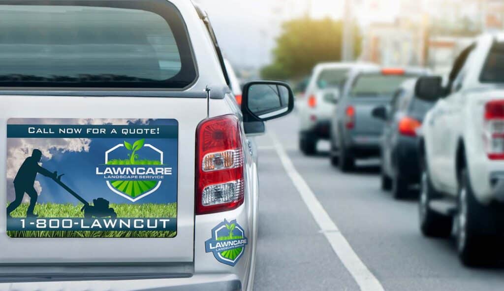 Truck with Lawncare Landscape Service ad and call-to-action for a quote on a busy road.