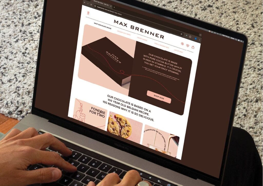 Max-Brenner-Case-Study-202418 Person browsing Max Brenner's chocolate shop website on a laptop, highlighting cocoa-rich products. | Sky Rye Design Person browsing Max Brenner's chocolate shop website on a laptop, highlighting cocoa-rich products.