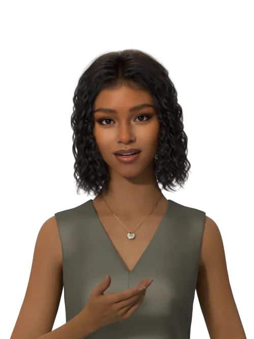 Smiling woman with curly hair wearing a necklace and green dress, gesturing with hand against a white background.