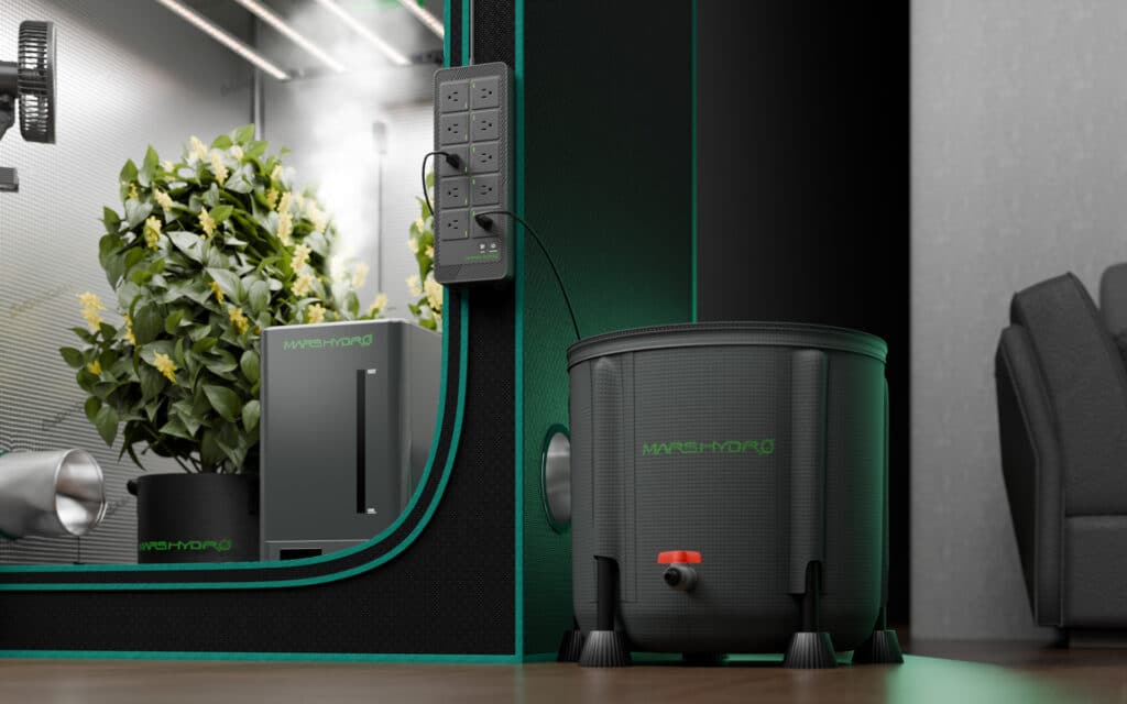 Hydroponic indoor garden setup with plants, humidifier, and water container for efficient home gardening.