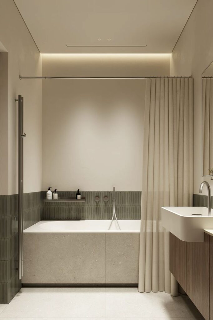 Modern bathroom with bathtub and beige tiles, featuring sleek fixtures and a minimalist design.
