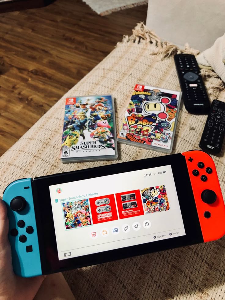 Nintendo Switch console with Super Smash Bros. and Super Bomberman game cases on a table.