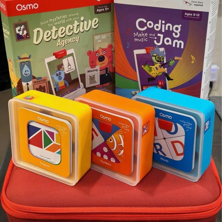 Osmo educational games for kids, featuring Detective Agency and Coding Jam kits with colorful boxes on a red case.