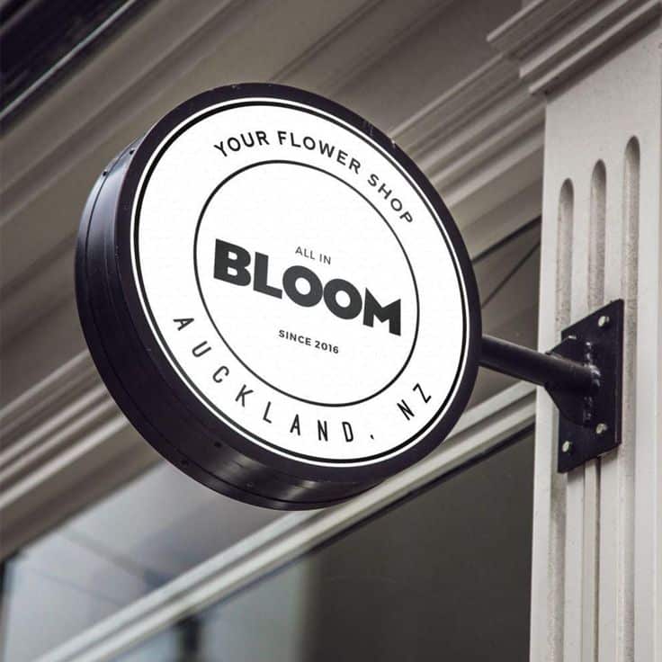 Round sign for All in Bloom flower shop in Auckland, NZ, featuring modern design since 2016.