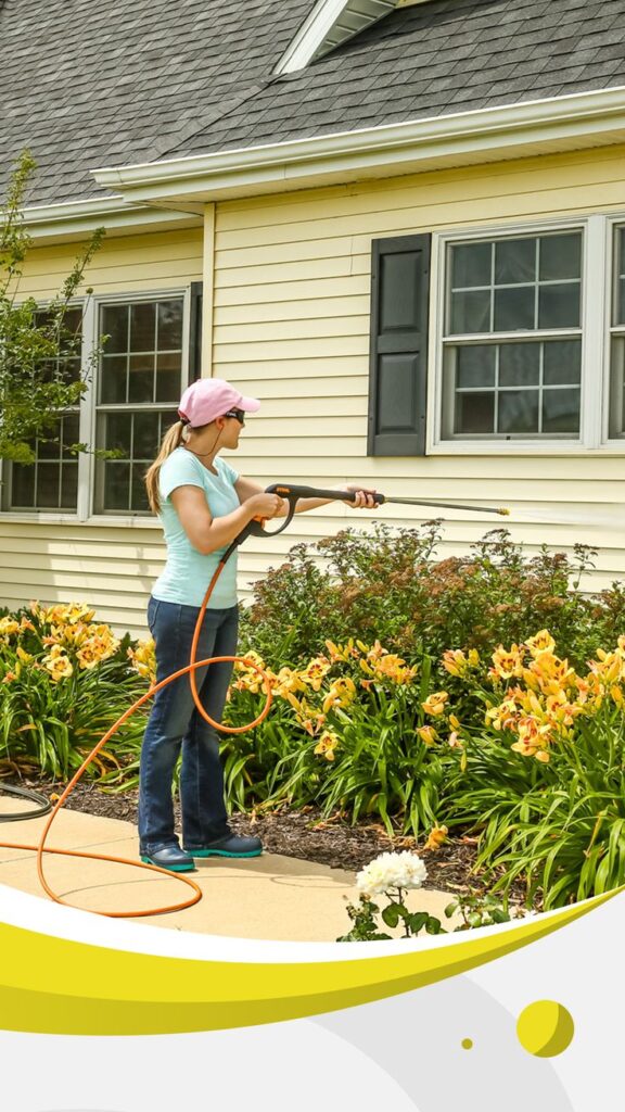 Petrol Pressure Washers Woman pressure washing a house exterior with yellow flowers in the garden, wearing a pink cap and teal shirt. | Sky Rye Design Woman pressure washing a house exterior with yellow flowers in the garden, wearing a pink cap and teal shirt.