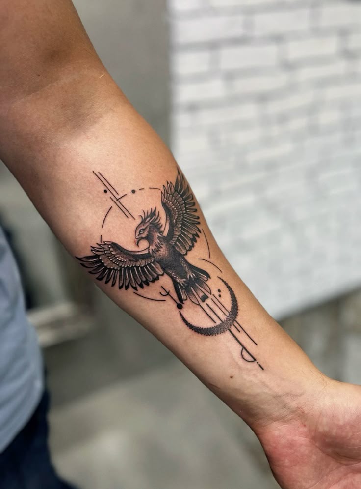 Geometric eagle tattoo on forearm, featuring intricate linework and abstract elements.