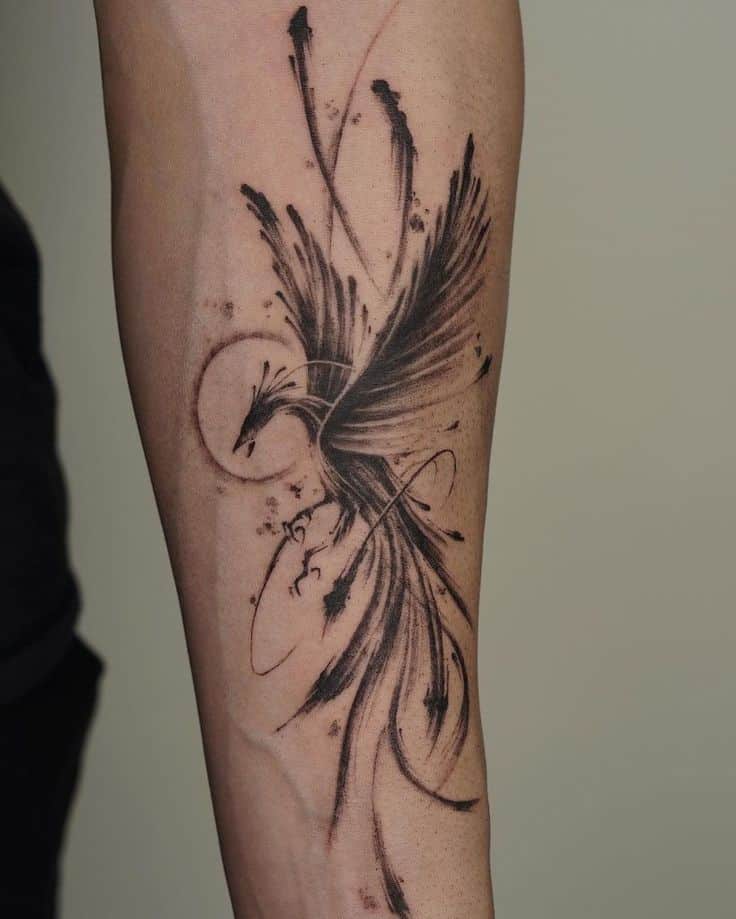 Abstract phoenix tattoo design on forearm, showcasing sweeping strokes and dynamic detail.