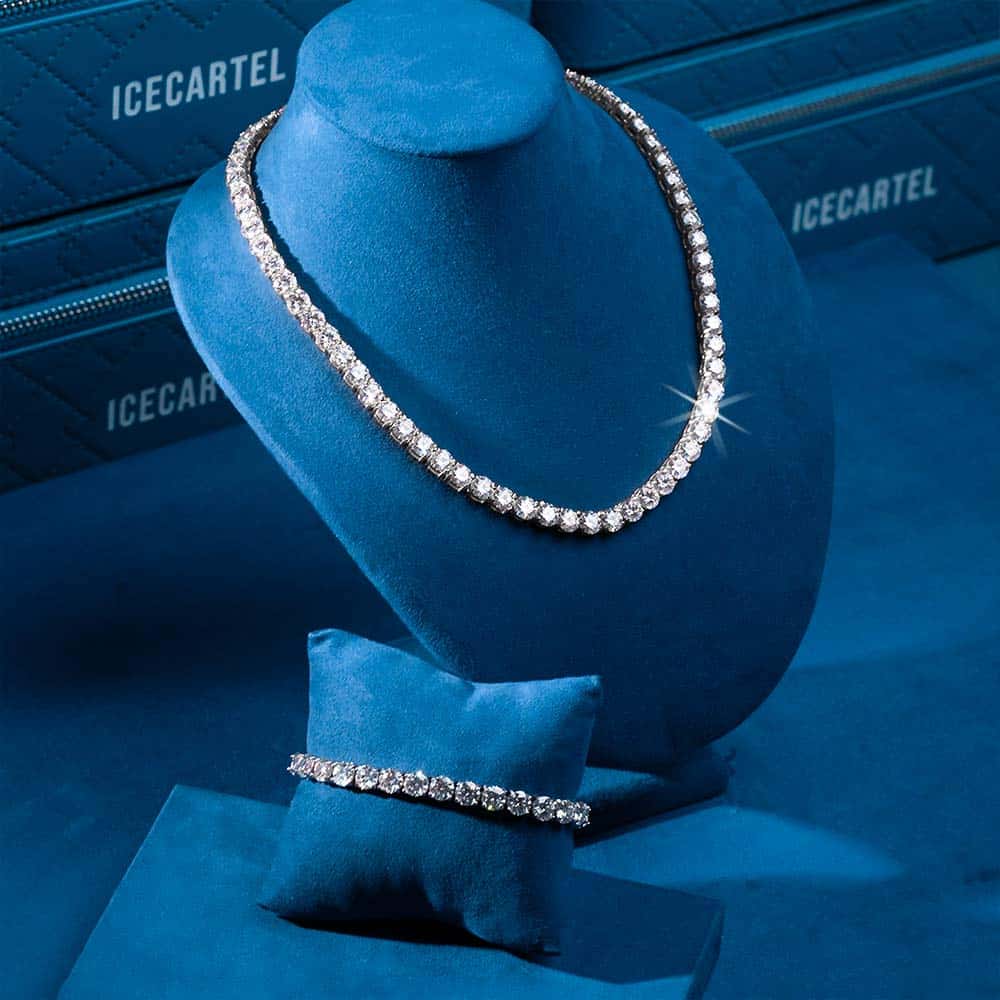 Luxurious diamond necklace and bracelet displayed on blue velvet, showcasing elegance and craftsmanship.
