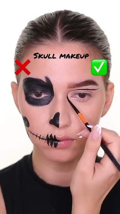 Person applying half-skull Halloween makeup with a brush; guidance on makeup techniques with correct and incorrect examples.