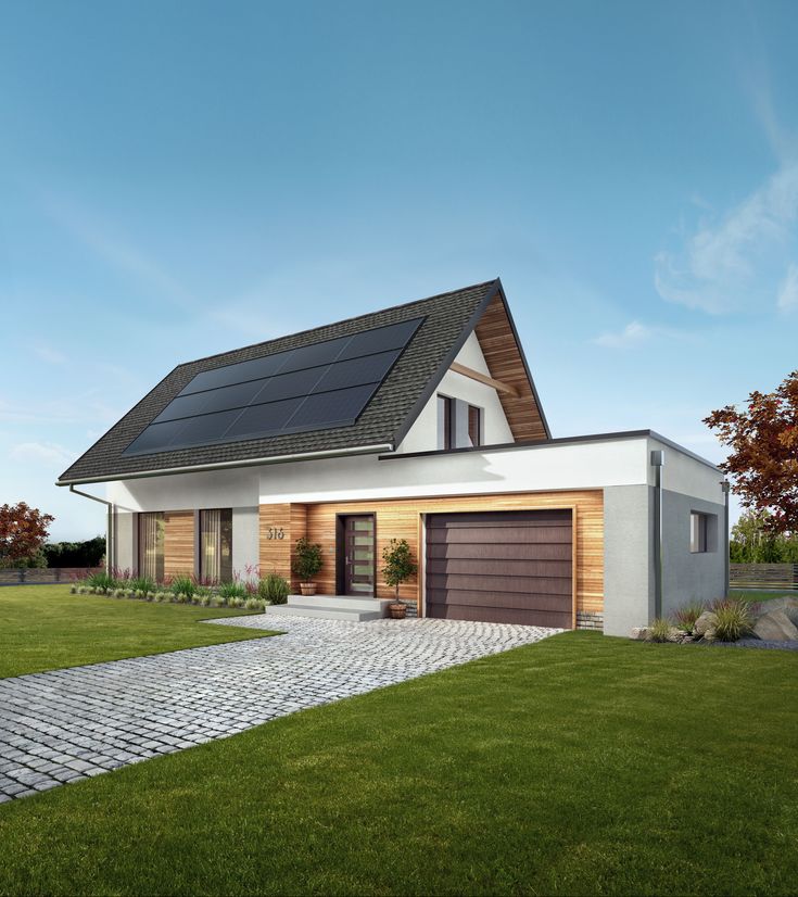 Modern house with solar panels, wood accents, driveway, and green lawn under a clear sky. Ideal for sustainable living.