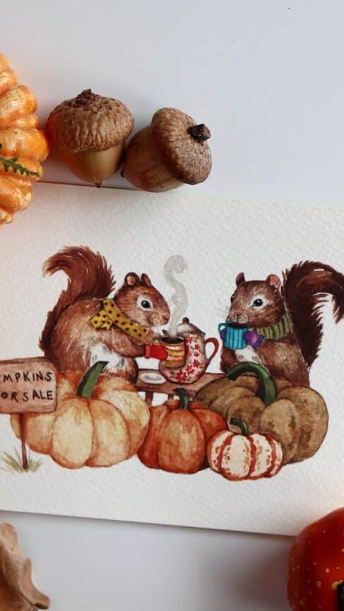 Cute squirrels with scarves enjoy tea among pumpkins and acorns, next to a Pumpkins for Sale sign.