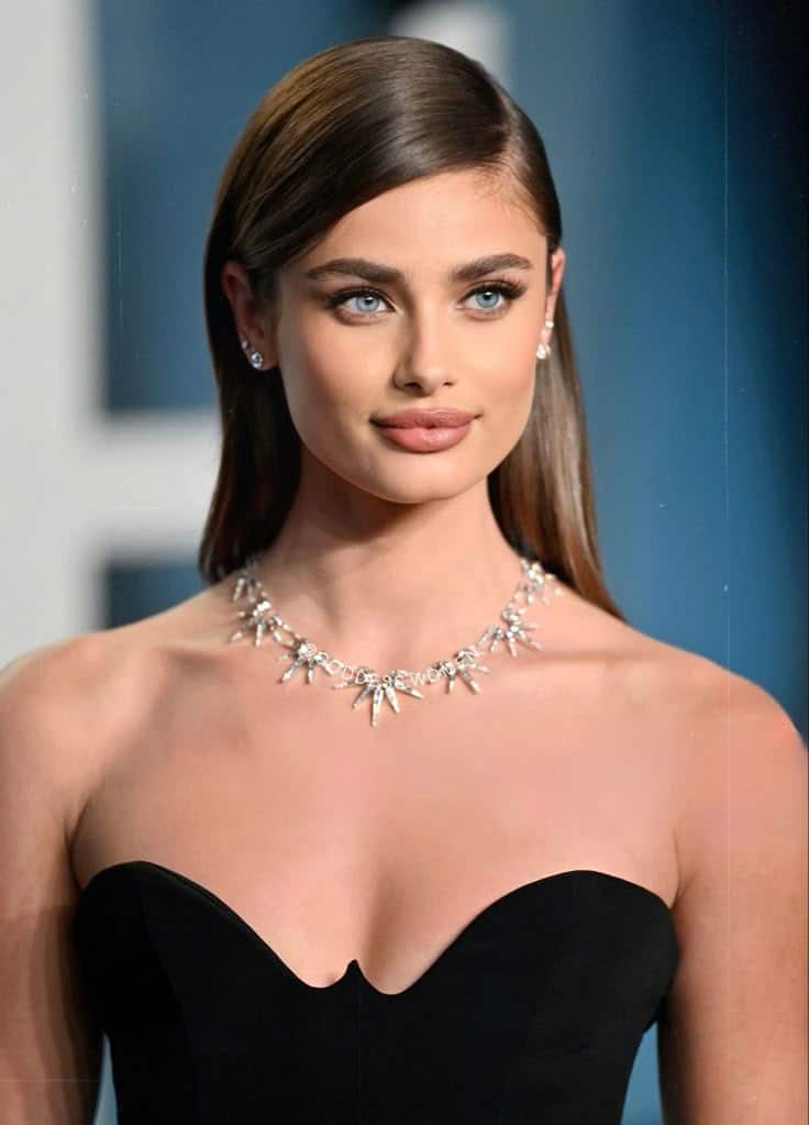 Taylor Hill Elegant woman in a black strapless dress and diamond necklace at a formal event. | Sky Rye Design Elegant woman in a black strapless dress and diamond necklace at a formal event.
