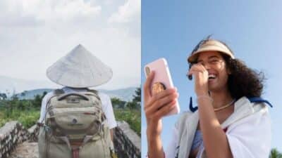 Traveler with cone hat and backpack outdoors; woman smiling with phone under clear blue sky.