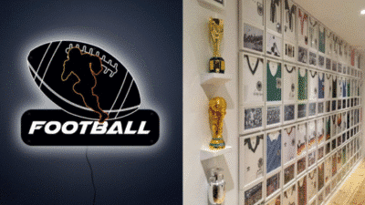 Neon football sign and wall of soccer jerseys and trophies illuminating a sports-themed room.