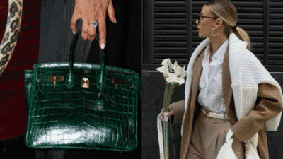 Woman carries green luxury handbag; stylish streetwear with white top, beige coat, and calla lilies in hand.
