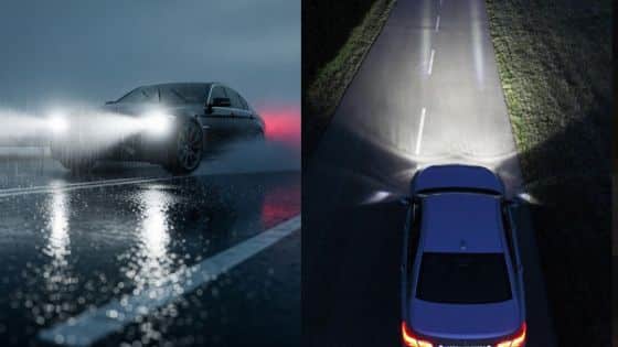 Car driving on a rainy road at night with headlights on, showcasing visibility and safety features.