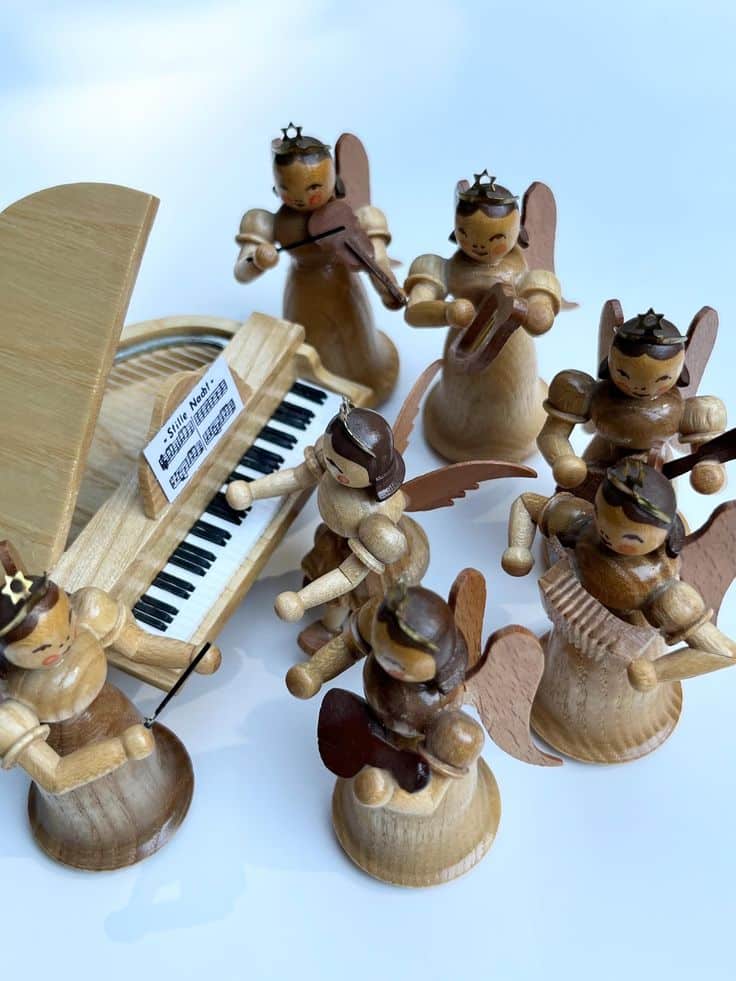 Vintage German Erzgebirge Ore Mountain Wooden Blank - Kunsthandwerk Angel Orchestra Musicians Wooden angel musicians play instruments around a toy piano, creating a charming and whimsical holiday scene. | Sky Rye Design Wooden angel musicians play instruments around a toy piano, creating a charming and whimsical holiday scene.