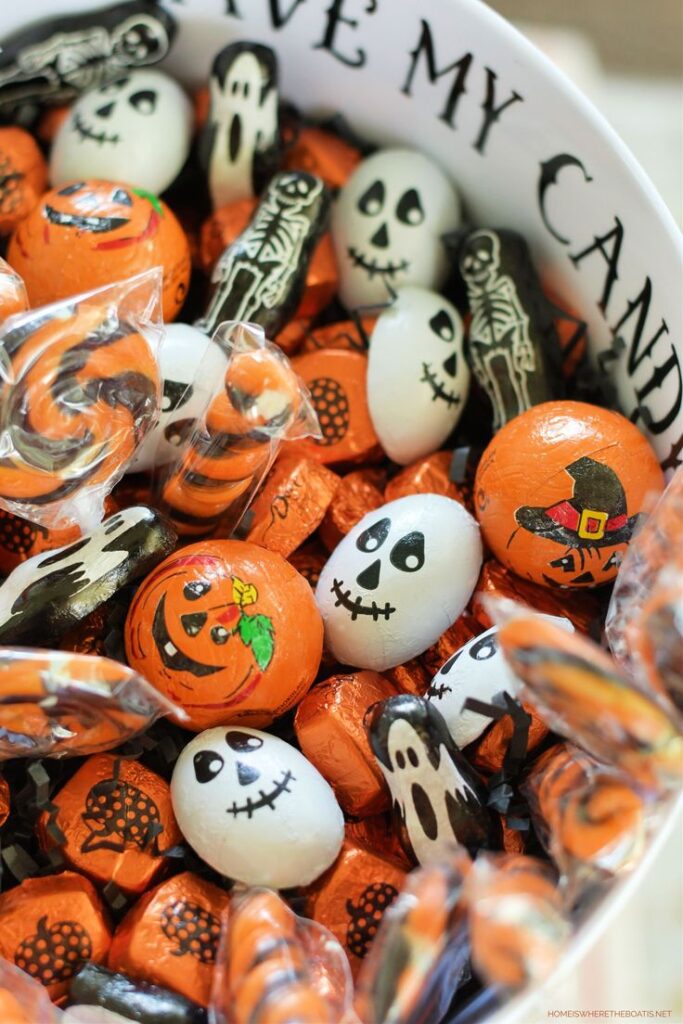 Witch Shoe Candy Bowl_ Easy to Scare Up for_ Halloween-themed candies in a bowl, featuring pumpkins, ghosts, and skeleton wrappers. Perfect for spooky festivities. | Sky Rye Design Halloween-themed candies in a bowl, featuring pumpkins, ghosts, and skeleton wrappers. Perfect for spooky festivities.