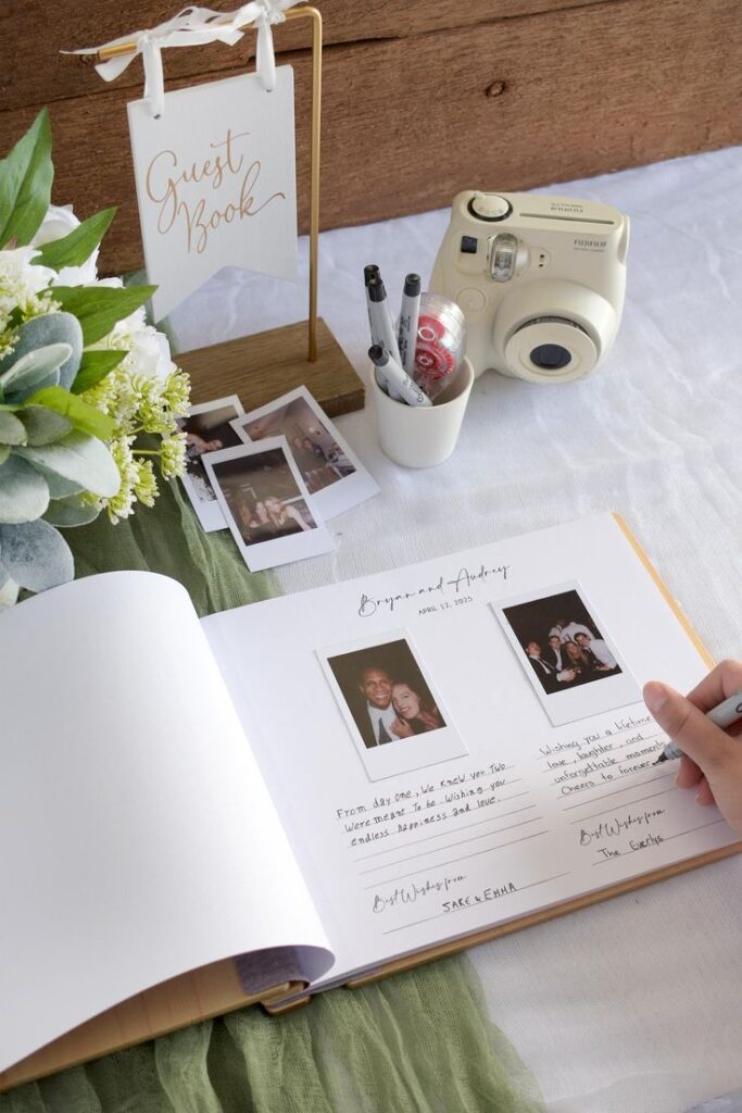 Wooden Wedding Guest Book - Personalized Laser Engraved Wedding Book Guest book display with instant photos, markers, and a camera, perfect for capturing wedding memories. | Sky Rye Design Guest book display with instant photos, markers, and a camera, perfect for capturing wedding memories.