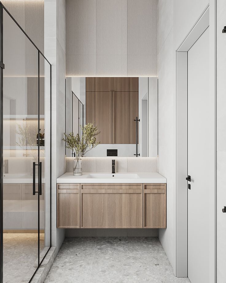 Year_ 2024_ 3Ds max 2023 _ Corona renderer_ Modern minimalist bathroom with wooden vanity, large mirror, sleek fixtures, and frosted glass shower door. | Sky Rye Design Modern minimalist bathroom with wooden vanity, large mirror, sleek fixtures, and frosted glass shower door.