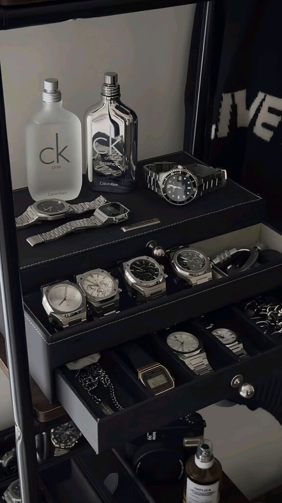 Men's luxury watch collection with Calvin Klein perfumes; elegant display of timepieces and fragrances.