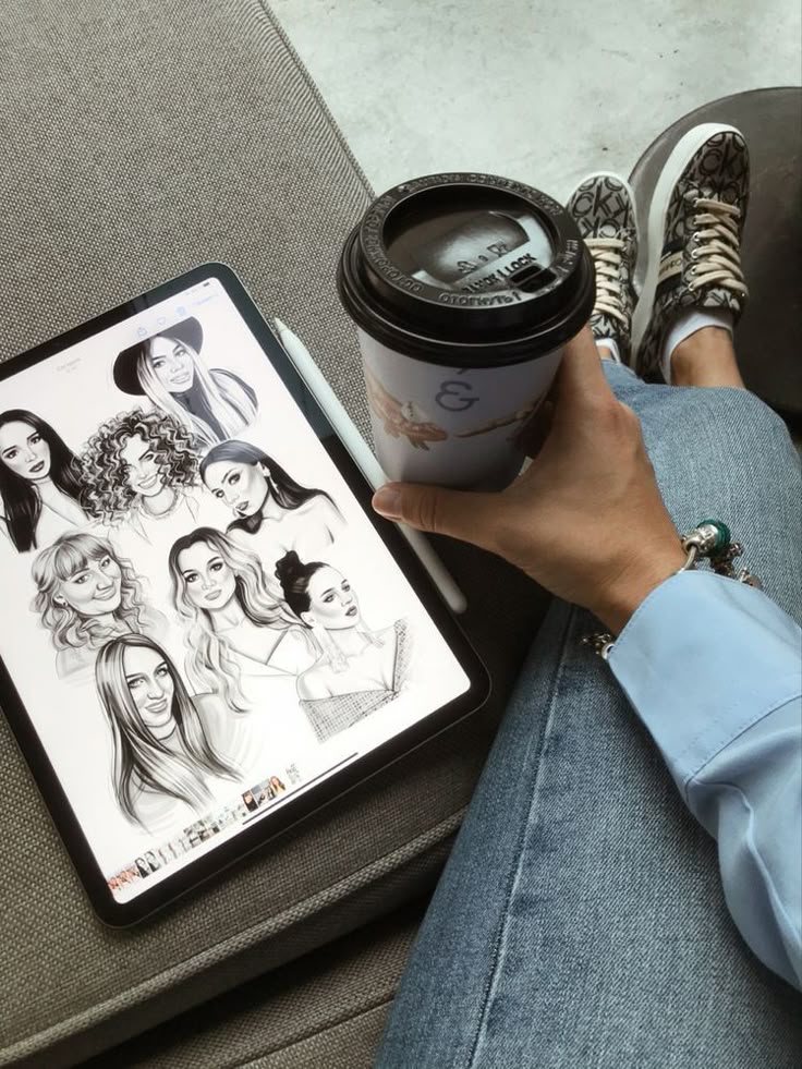 art Person holding a coffee cup, drawing portraits on a tablet while relaxing with stylish sneakers and casual jeans. | Sky Rye Design Person holding a coffee cup, drawing portraits on a tablet while relaxing with stylish sneakers and casual jeans.