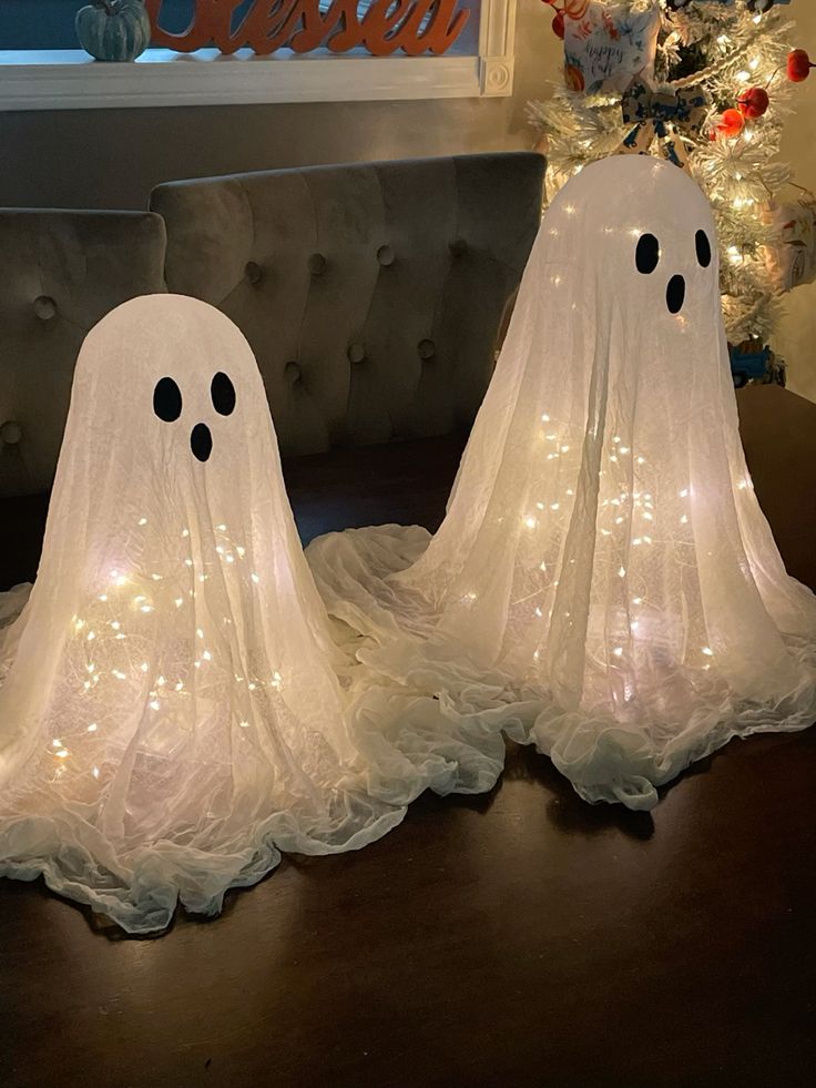 bb3ef9184b2a211c1b58bb324884e5b0 Ghost decorations with fairy lights on a table, creating a festive Halloween ambiance indoors. | Sky Rye Design Ghost decorations with fairy lights on a table, creating a festive Halloween ambiance indoors.