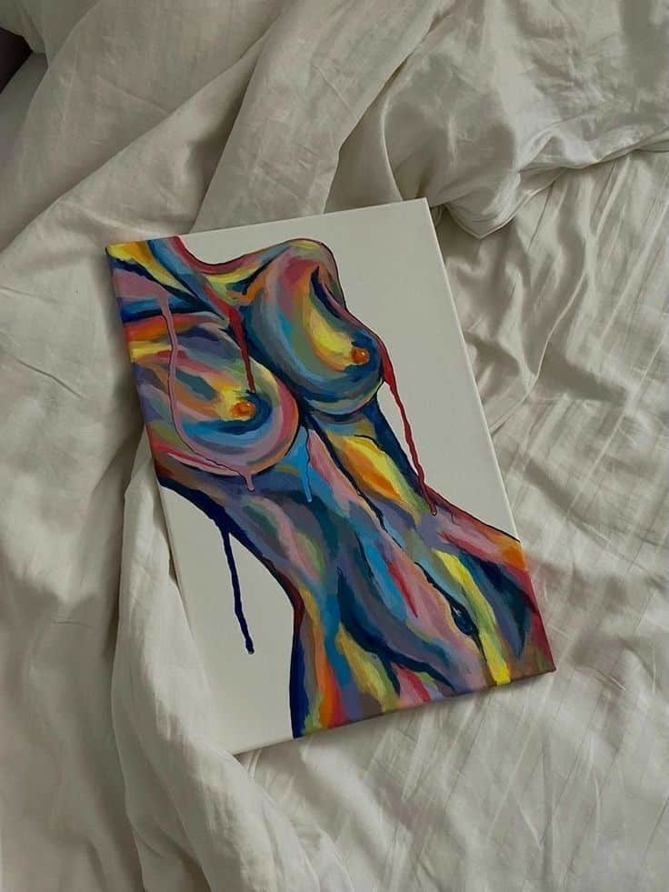 Colorful abstract painting of a human torso on white sheets, showcasing vibrant brushstrokes and artistic expression.