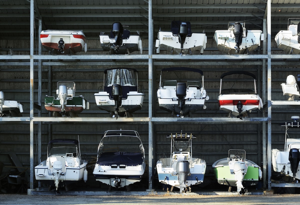 boat storage which method is best for you_1 Stacked motorboats in a storage facility, showcasing various models and colors. | Sky Rye Design Stacked motorboats in a storage facility, showcasing various models and colors.