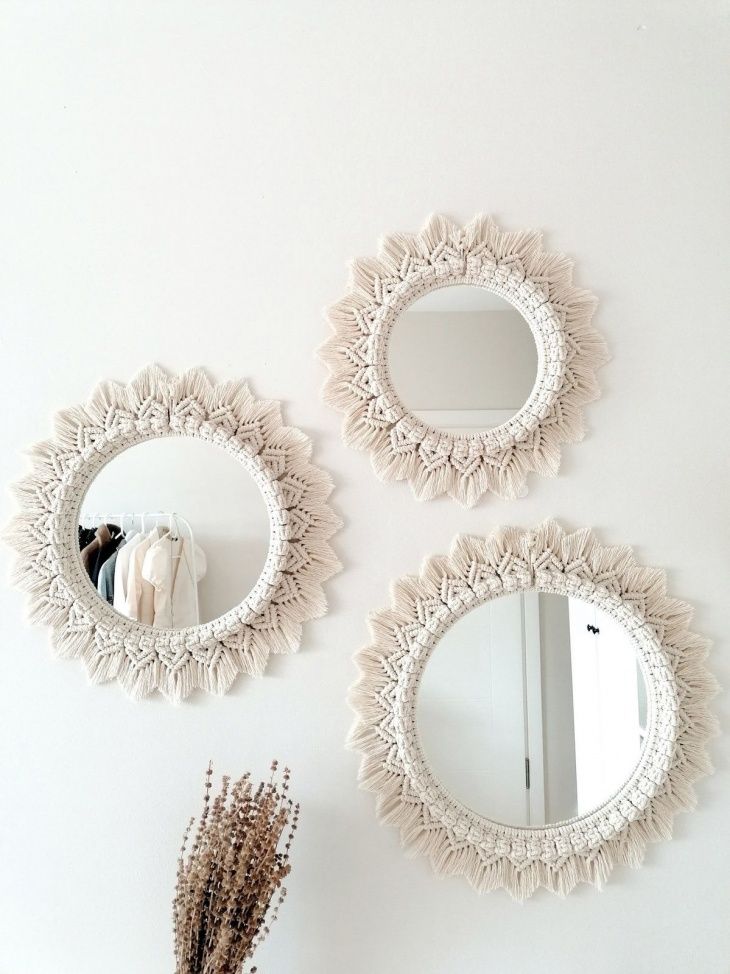Three round macramé mirrors on a white wall add boho charm to the modern decor.