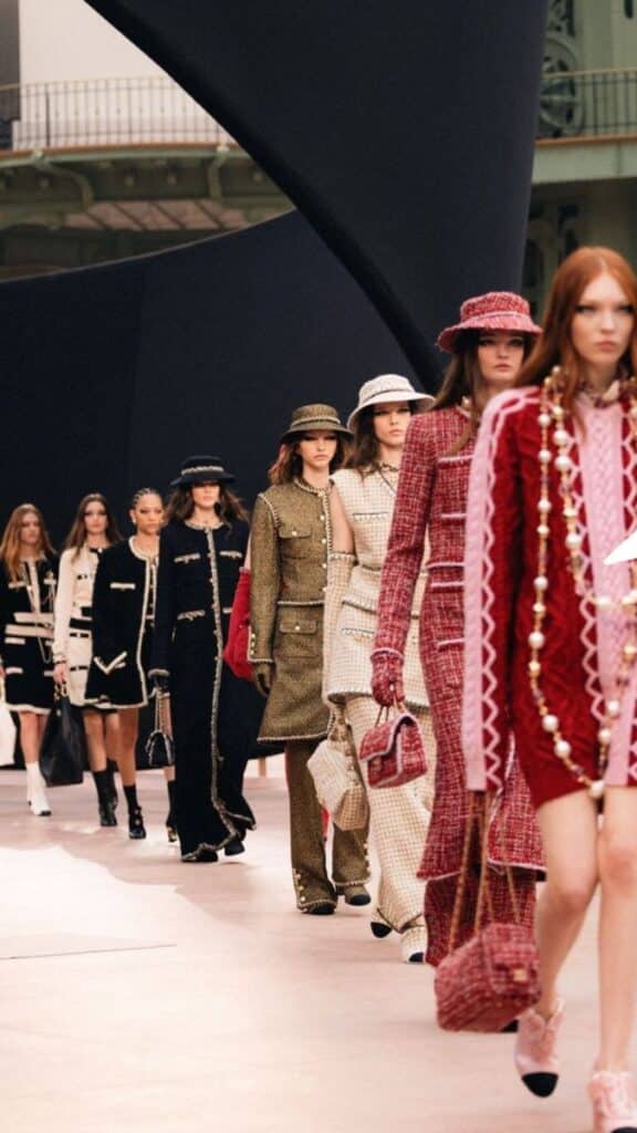 da30ca3f-c5d6-4a43-b9b9-d1fcd99bf401 Fashion models showcase designer tweed outfits on the runway at a high-end fashion show. | Sky Rye Design Fashion models showcase designer tweed outfits on the runway at a high-end fashion show.